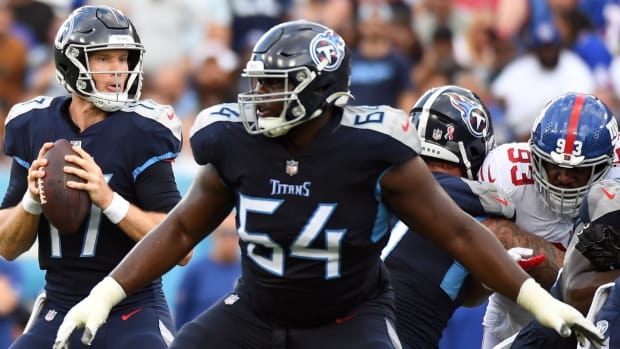 Tennessee Titans quarterback Ryan Tannehill (17) drops back to pass with protection from guard Nate Davis (64) during the first half against the New York Giants at Nissan Stadium.
